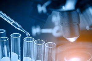 Laboratory microscope and test tubes with pipette highlighting MK-677 latest research 2025 in a science lab